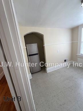 Wilson apartment for rent - A room with a doorway leading to another room and a window on the wall.