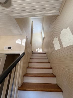 Wilson apartment for rent - A staircase with white walls and wooden steps.