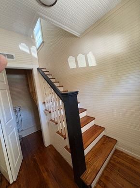 Wilson apartment for rent - A staircase with a black railing and wooden steps.