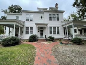 Wilson apartment for rent - A white house with a brick pathway leading to the front door.