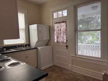 Wilson apartment for rent - A kitchen with a stove top oven and a refrigerator.