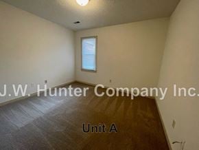 Wilson apartment for rent - A room with a window and a wooden floor.