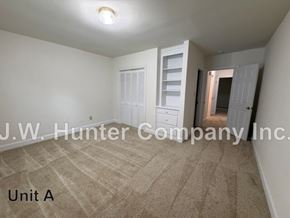 Wilson apartment for rent - A room with carpeted floor and white walls, with a doorway leading to another room.
