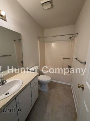 Wilson apartment for rent - A bathroom with a sink, toilet and bathtub.
