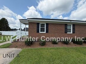 Wilson apartment for rent - A brick house with a sign that says J.W. Hunter Company Inc.