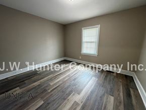Wilson apartment for rent - A room with wooden flooring and a window is labeled as Unit A.