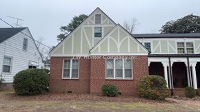 Wilson apartment for rent - A white building with a sign that says J.W. Hunter Company.