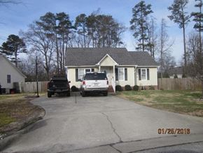 Wilson house for rent - A house with a car parked in front of it.