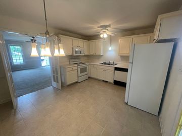 Wilson house for rent - A kitchen with white appliances and cabinets.