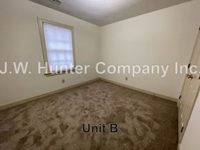 Wilson apartment for rent - A carpeted room with a window and a door, labeled Unit B.