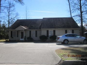 Wilson apartment for rent - a white house with a car parked in front of it
