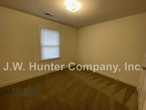Wilson apartment for rent - A room with a window and carpeting with the name J.W. Hunter Company, Inc. on it.