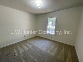 Wilson apartment for rent - A room with a window and carpeted floor.