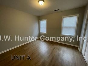 Wilson apartment for rent - A room with wooden flooring and two windows, labeled as Unit A.