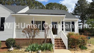 Wilson apartment for rent - A white house with a porch and a sign that says "Hunterdon".