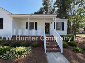 Wilson apartment for rent - A white house with a porch and a sign that says J.W. Hunter Company.