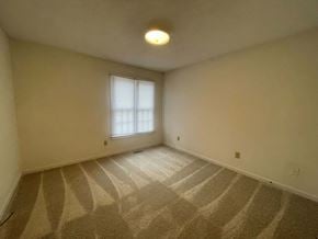 Wilson apartment for rent - A room with a carpeted floor and a window.