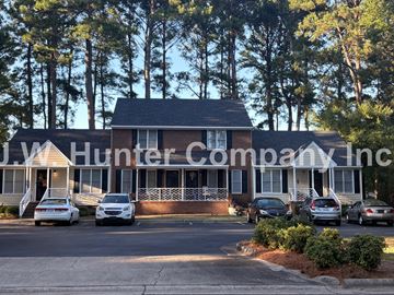 Wilson apartment for rent - A building with the sign U.W. Hunter Company Inc. in front of it.