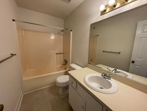 Wilson apartment for rent - A bathroom with a sink, toilet, and shower.