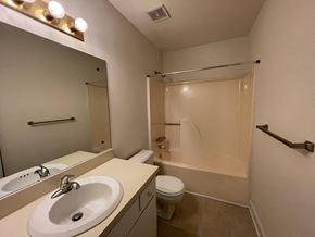 Wilson apartment for rent - A bathroom with a sink, toilet, and shower.