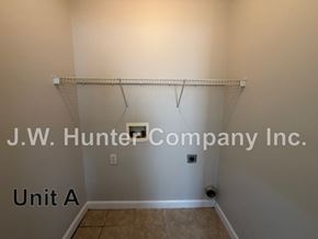 Wilson apartment for rent - A white wall with a shelf and J.W. Hunter Company Inc. written on it.