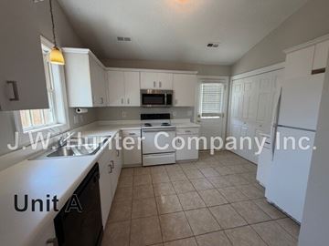 Wilson apartment for rent - A kitchen with white cabinets and appliances is on the market with J.W. Hunter Company Inc.