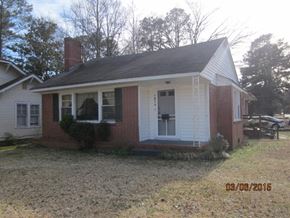 Wilson house for rent - A small house with a red brick exterior and a white door.