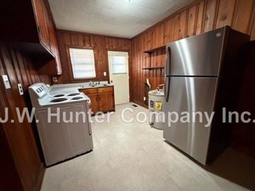 Wilson apartment for rent - A kitchen with a stove, refrigerator, and sink.