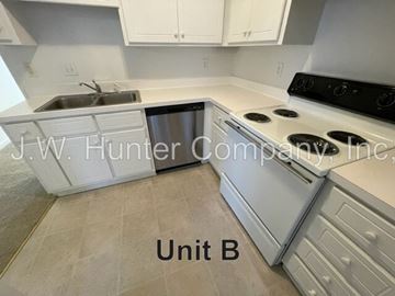 Wilson apartment for rent - A kitchen with a stove, sink, and cabinets.