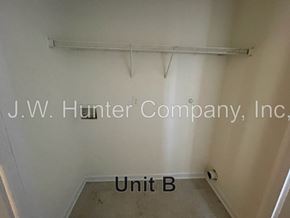 Wilson apartment for rent - A white wall with a shelf and a sign that says J.W. Hunter Company, Inc.