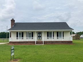 Wilson house for rent - a white house with a white porch and a sign