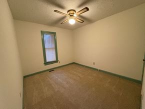 Wilson house for rent - A room with a ceiling fan and a window.