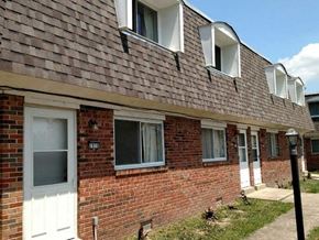 New Baden apartment for rent - a brick house with three windows and a white door