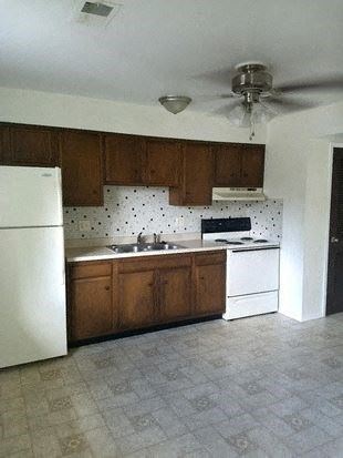 New Baden apartment for rent - a kitchen with a white refrigerator and stove and a ceiling fan