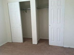 New Baden apartment for rent - an empty bedroom with a closet and two doors