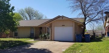 Stillwater house for rent - a house with a white garage door and a driveway