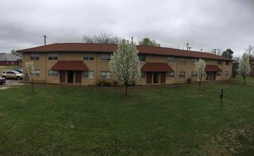 Stillwater apartment for rent - the front of an apartment building with green grass and trees