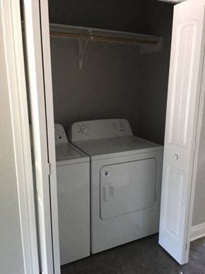 Eunice apartment for rent - a white washer and dryer in a small closet
