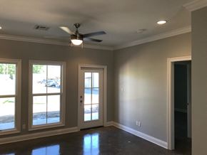 Eunice apartment for rent - a living room with a ceiling fan and three windows