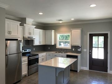 Eunice apartment for rent - a kitchen remodel with white cabinets and stainless steel appliances