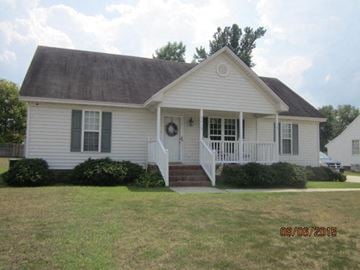 Wilson house for rent - a white house with a porch and a lawn