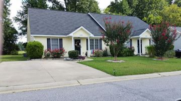Rocky Mount apartment for rent - a yellow house with a blue roof on a street