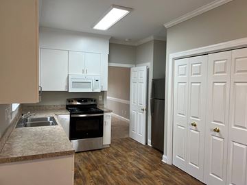 Wilson apartment for rent - A kitchen with white cabinets and a stainless steel oven.