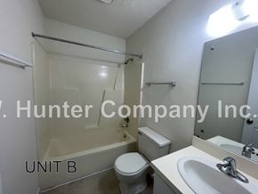 Wilson apartment for rent - A bathroom with a toilet, sink, and bathtub.