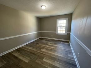 Wilson apartment for rent - A room with wooden flooring and a window.