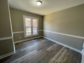 Wilson apartment for rent - A room with a window and wooden flooring.
