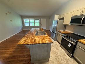 Atlanta house for rent - A kitchen with a wooden island and stainless steel appliances.