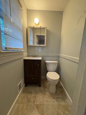 Atlanta house for rent - A bathroom with a toilet and a cabinet.