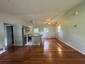 Atlanta house for rent - A kitchen with a refrigerator, sink, and a window.