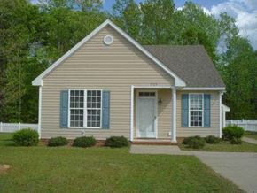 Rocky Mount house for rent - a tan house with blue shutters and a lawn